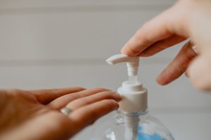 Hand Sanitizer squirting into hand, by Kelly Sikkema