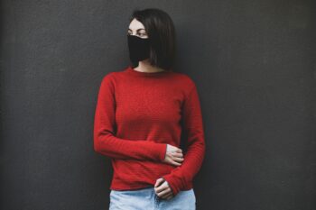 woman in red sweater and blue denim jeans