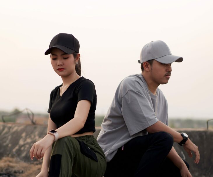 two man and woman wearing fitted caps