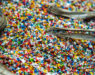 Sack of sorted multicoloured shredded plastic garbage at waste recycling factory